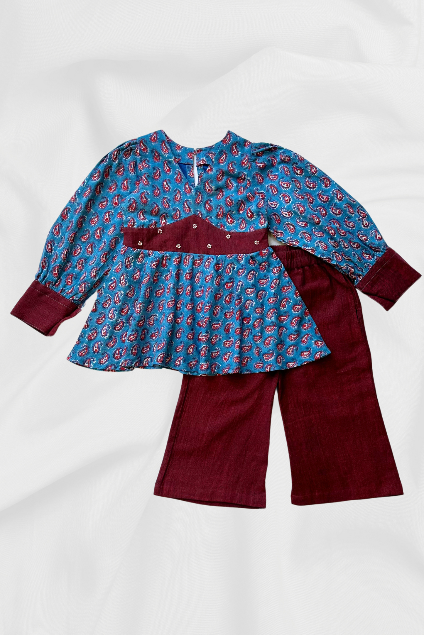 Blue top and maroon pants