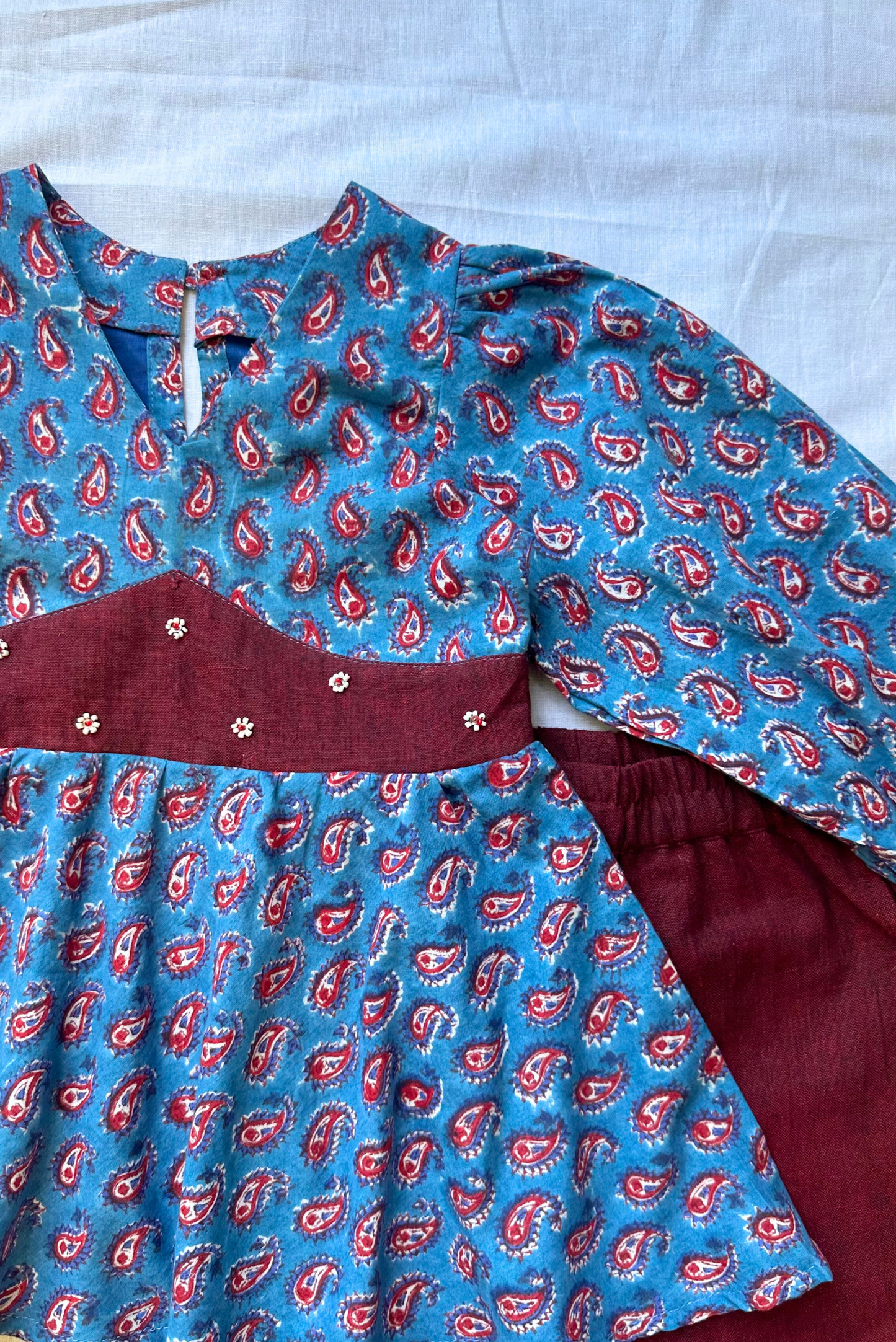 Blue top and maroon pants